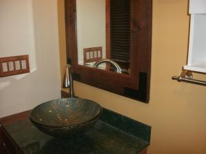 a bathroom with a bowl sink and a mirror at Cool Springs Inn in Michigan City