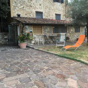 a patio with chairs and a table in front of a building at Villetta Gabriella in Impruneta