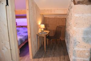 ein kleiner Tisch und Stuhl in einem Zimmer mit einem Bett in der Unterkunft Gite de charme la Chabotte - Royans / Vercors in Châtelus