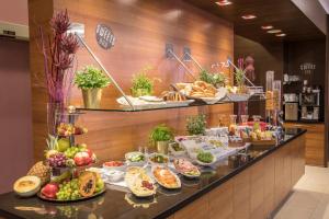 a buffet table filled with different types of food at Hotel Mercure Graz City in Graz