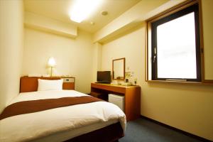 3s HOTEL HIRATSUKA客房内的一张或多张床位