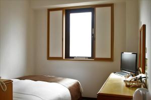 3s HOTEL HIRATSUKA客房内的一张或多张床位