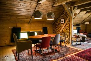 a dining room with a wooden table and chairs at Zielna Farma in Blanki