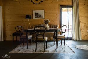a dining room with a table and chairs at Zielna Farma in Blanki +43 photos