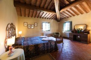 a bedroom with a bed and a dresser and a mirror at Tenuta di Ghizzano Resort in Ghizzano +151 photos