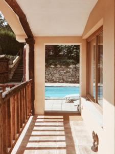 an open door of a house with a swimming pool at Casa Os Curras in Culleredo