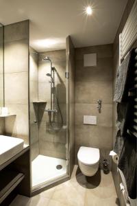 a bathroom with a shower and a toilet and a sink at Spirklhof in Bodenkirchen +20 photos