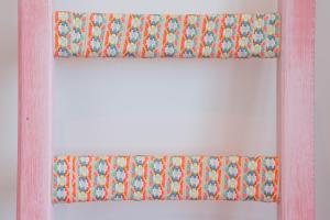 an orange and blue window curtain on a white wall at Cocor Suites & Design in Naples