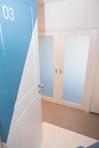 a room with a white door and a mirror at Cocor Suites & Design in Naples