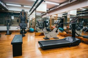 a gym with several treadmills and machines at Residence Hotel Torino Uno in Turin