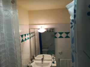 a bathroom with a sink and a toilet and a mirror at Affittacamere Lo Scoiattolo di Mannocchi Lorella in Porto SantʼElpidio +16 photos