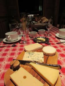 a table with cheese and wine glasses on a table at Maison d'hôtes La Ferme Pierre*** in Donnenheim +7 photos
