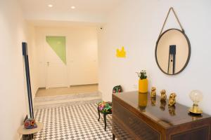 a room with a dresser and a mirror on the wall at Cocor Suites & Design in Naples
