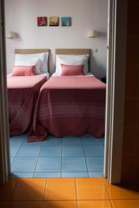 two beds sitting next to each other in a room at B&B Attico Partenopeo in Naples