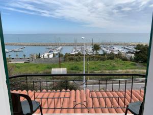 a view from a balcony of a beach with a view of the ocean at Baia dei Gabbiani in San Lorenzo al Mare