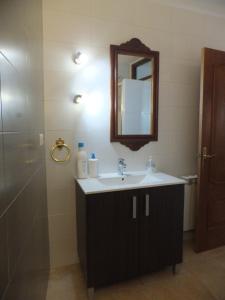 a bathroom with a sink and a mirror and a shower at Puerta del Arco in Riópar