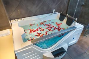 a bath tub filled with red sprinkles in a bathroom at Casa Montana Munnar in Munnar