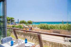 a balcony with a view of the beach and the ocean at Martinhal Sagres Beach Family Resort Hotel in Sagres