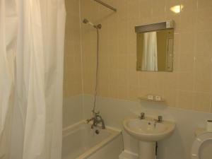 a bathroom with a sink and a toilet and a shower at The Crown Hotel in Stoke on Trent +12 photos