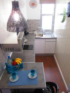 a small kitchen with two cups on a table at Estudio con encanto en la playa (aptos.salinetas) in Telde