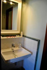 a bathroom with a white sink and a mirror at Appartamento Le Corti in Pistoia