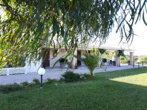 a house with a lawn in front of it at TENUTA ALMATELLUS in Torre Lapillo