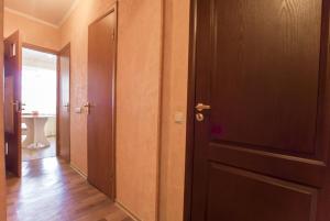 a room with a door and a hallway with wood floors at Квартира in Kamianske