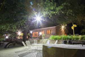 a house with a table and chairs in front at night at Klippan River Lodge in Groblersbrug