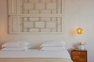 a bedroom with two beds and a mirror on the wall at Herdade do Ananás in Ponta Delgada