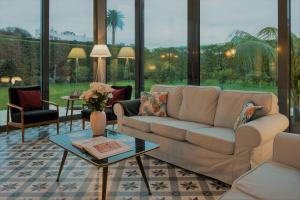 a living room with a couch and a table at Herdade do Ananás in Ponta Delgada