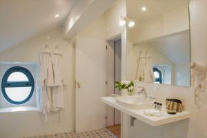 a bathroom with a sink and a mirror at Herdade do Ananás in Ponta Delgada