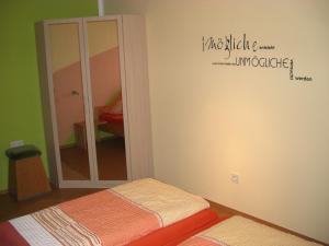 a room with two beds and a mirror at Ferienwohnung Seidl in Waffenbrunn