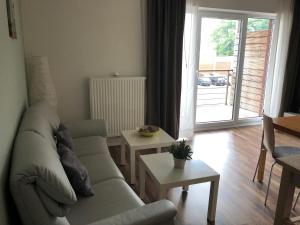 a living room with a couch and a table at Fehnferien in Rhauderfehn