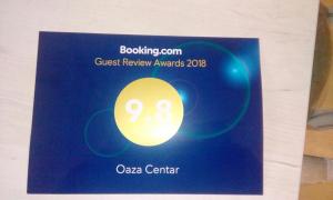 a sign for a guest review awards at Oaza centar in Novi Sad