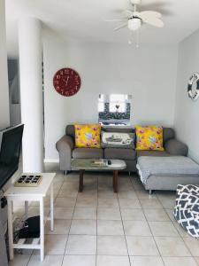 a living room with a couch and a table at 9 Casablance Ballito~Beach on your doorstep. in Ballito