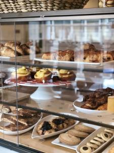 a display case filled with different types of pastries at Hotel Viking in Newport