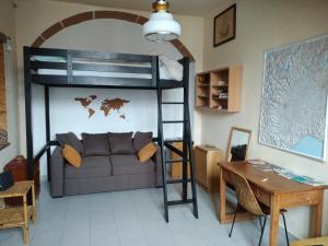 a living room with a bunk bed and a couch at Mansarda in Vanchiglia in Turin