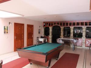 a living room with a pool table in it at Hotel Hunor in Sátoraljaújhely