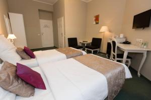 Łóżko lub łóżka w pokoju w obiekcie Leone Aparthotel