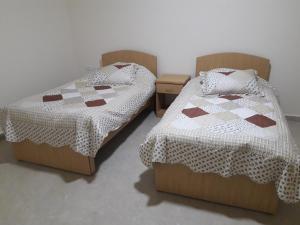 two twin beds sitting in a room with at Cypress Tree Apartments in Bethlehem