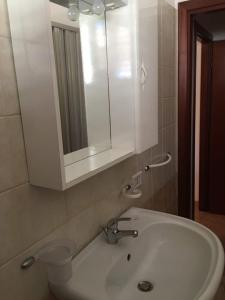 a bathroom with a sink and a mirror at Appartamento Il Corallo Blu in Lampedusa