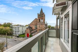 a balcony with a view of a church at Stunning Penthouse in the Heart of the City in New Orleans