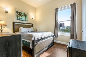 a small bedroom with a bed and a window at Stunning Penthouse in the Heart of the City in New Orleans