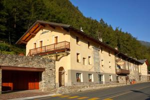 a large building on the side of a road at Locanda La Clusaz in Gignod