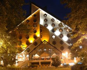 a building with a lit up facade at night at Bianca Resort & Spa in Kolašin