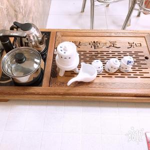 a wooden tray with utensils on top of a table at Best Warm B&B in Huxi