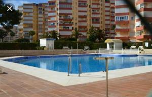 a large swimming pool in front of a building at Canoa in Torrox Costa