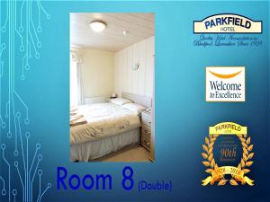 A bed or beds in a room at Parkfield Hotel