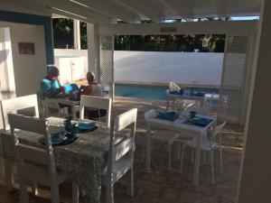 two people sitting at a table in a restaurant at B&B Villa Luna in Bayahibe
