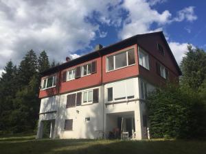 a large house with a red and white at Ferienwohnung Börner ll in Kniebis